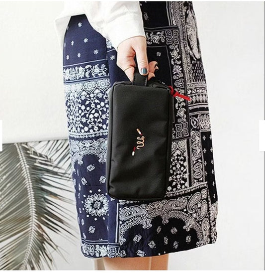 Black embroidered cosmetic travel pouch organizer bag for daily essentials.