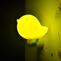 Cute yellow bird plug-in LED night light for bedside illumination.