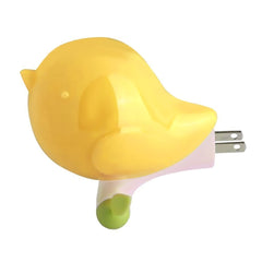 Cute yellow bird plug-in LED night light for bedside illumination.