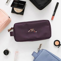 Black embroidered cosmetic travel pouch organizer bag for daily essentials.